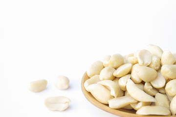 groundnuts on wooden spoon isolated on white background