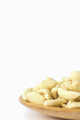 groundnuts on wooden spoon isolated on white background