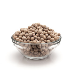 Front view of Organic White Pepper (Piper nigrum) in glass bowl isolated on white background.