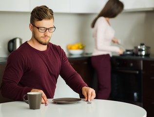 Man waiting for food on a kitchen at home