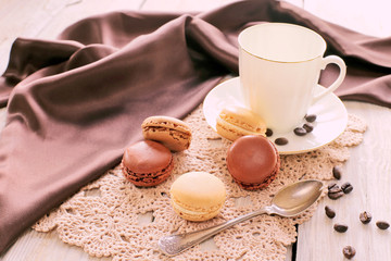 Porcelain cup with macaroons on lace