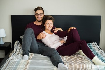 Fototapeta na wymiar Cheerful couple on a bed at home