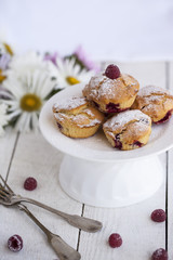 Muffins with raspberries,sprinkled with powdered sugar.selective focus