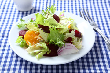 Delicious salad with onions, tangerines and beet