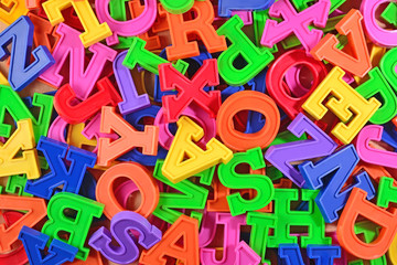 Fototapeta premium Colorful plastic alphabet letters as background