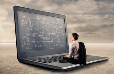 Young businessman staring at a giant screen