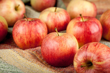 Ripe red apples on linen tablecloth