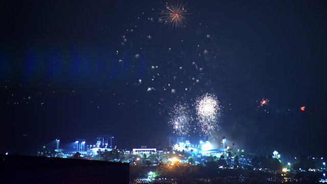 Time lapse footage with pan right motion of Independence Day fireworks over Dodger Stadium in Los Angeles on 4th of July