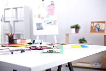 Desk of an artist with lots of stationery objects. Studio shot