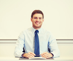 smiling businessman sitting in office