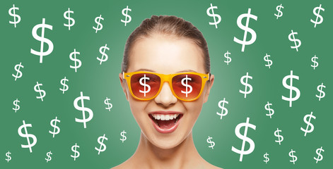 happy woman in shades with dollar currency sings