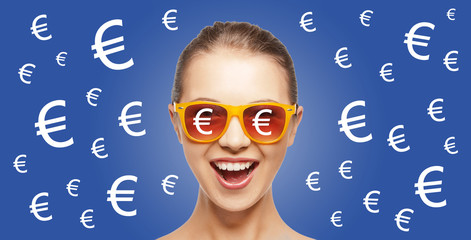 happy woman in shades with euro currency sings