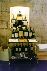 wine bottles on a table and in a closet