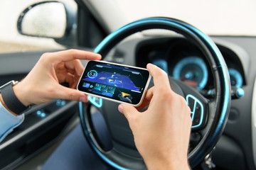 hands with navigator on smartphone in car