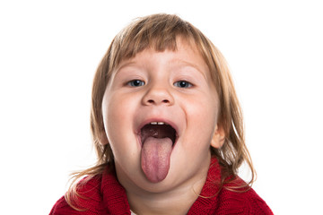 The girl looks in the frame on and showing tongue. Red sweater