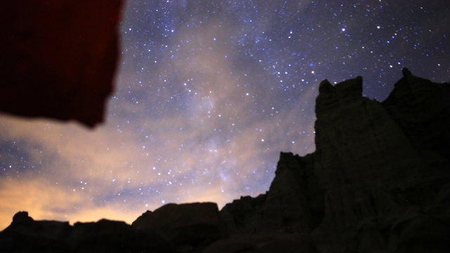 3 axis motion controlled astrophotography time lapse footage with dolly right, tilt up & pan right motion of Milky Way galaxy through eroded desert sandstone landscape in Red Rock Canyon State Park, California