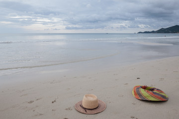 Beach on tropical island. Clear blue water, sand, clouds. 