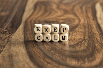 Word KEEP CALM on wooden cubes