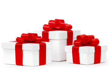 White gift boxes with red ribbon bows