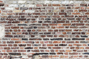 a brick wall made from assorted bricks