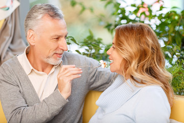 Nice adult couple sitting in the cafe