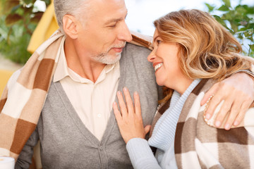 Nice adult couple sitting in the cafe
