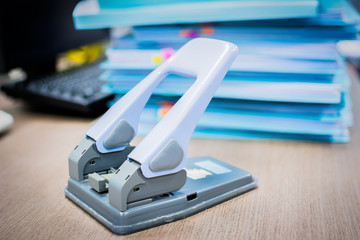 Hole puncher. Office paper hole puncher on desk