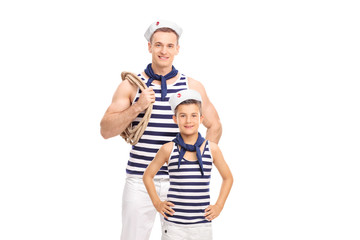 Young man and a kid in sailor outfits