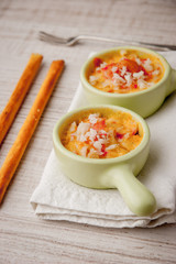 Crab cocotte with breadsticks and  vintage fork on the white napkin vertical