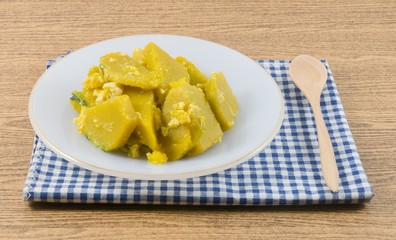 Stir Fried Pumpkin with Egg in A White Plate