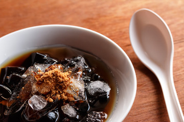 grass jelly dessert  in syrup with ice and brown sugar.