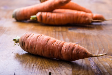 Fresh homemade carrot loose on a wooden table.