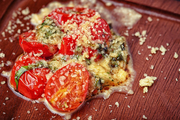 Salad of roasted tomato and cheese on desk