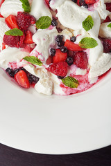 delicious ice cream with berries and pieces of meringue