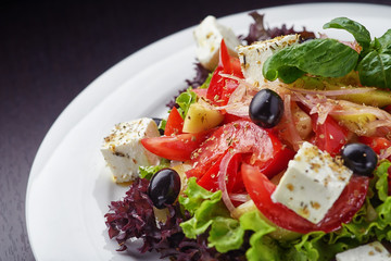 Closeup of vegetable salad on white plate