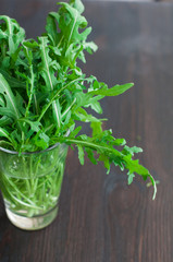 fresh ruccola leaves on the wooden background