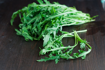 fresh ruccola leaves on the wooden background