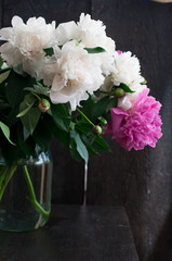 white and pink peonies on rustic wooden background