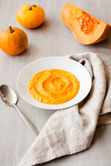 Pumpkin cream-soup with seeds in a white plate