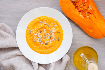Pumpkin cream-soup with seeds in a white plate