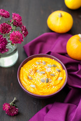 Pumpkin cream-soup with seeds in a plate