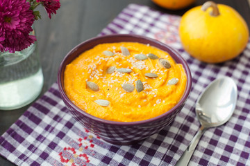 Pumpkin cream-soup with seeds in a bowl