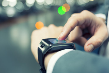 In parking car a man using his smart watch. Close-up hands