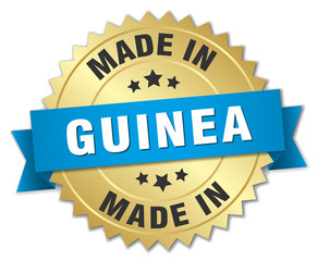 made in Guinea gold badge with blue ribbon