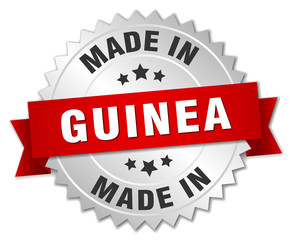 made in Guinea silver badge with red ribbon