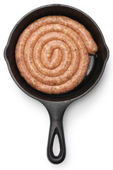 raw cumberland sausage, spiral pork sausage on skillet isolated on white background

