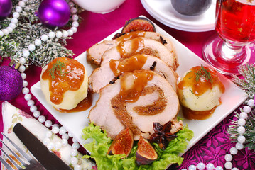 christmas dinner with loin of pork stuffed with figs and potato