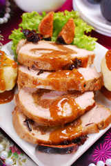 christmas dinner with loin of pork stuffed with figs and potato