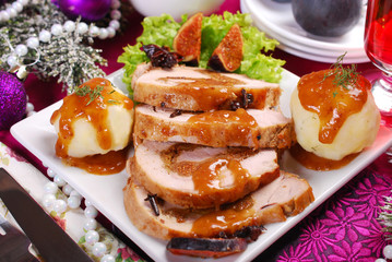 christmas dinner with loin of pork stuffed with figs and potato