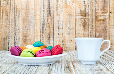 Colorful macarons on vintage pastel background. Macaron or Macar